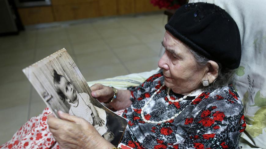 Frecha Amar, 84, from a Moroccan descent, poses with a picture of her baby, who she says was abducted in 1958, on June 29, 2016 at her home in Kfar Chabad, near Tel-Aviv. 
Amar is one of the thousands of Israelis, mainly from Jewish Yemenite families, who claim their babies were abducted more than 60 years ago and handed to adoption. Such stories of babies from immigrant families disappearing have been told in Israel for decades, but growing calls to unseal official documents on the allegations mean new lig