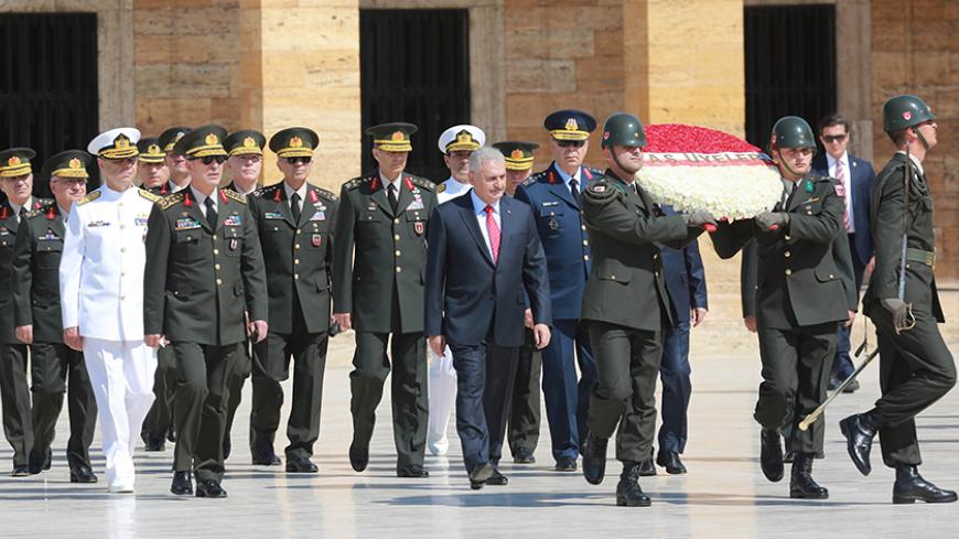 Turkey's Prime Minister Binali Yildirim (2-R) and Chief of the General Staff of the Turkish Armed Forces, Hulusi Akar (L) are seen during Turkish Supreme Military Council (YAS) members' visit at Anitkabir, mausoleum of Mustafa Kemal Ataturk in Ankara, on July 28, 2016. / AFP / ADEM ALTAN        (Photo credit should read ADEM ALTAN/AFP/Getty Images)