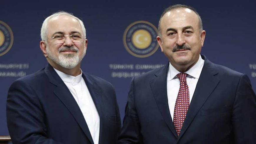 Turkish Foreign Minister Mevlut Cavusoglu (R) and Iran's Foreign Minister Mohammad Javad Zarif shake hands following a joint press conference at the Foreign Ministry in Ankara on August 12, 2016.  / AFP / ADEM ALTAN        (Photo credit should read ADEM ALTAN/AFP/Getty Images)