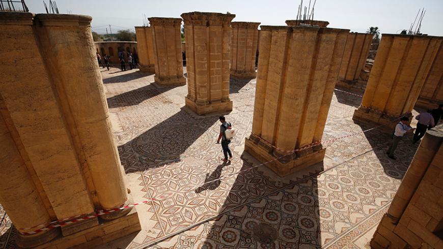 A Palestinian man removes weeds from the Hisham's Palace archaeological site, located five kilometres north of the West Bank city of Jericho, on October 20, 2016, after the mosaic in the palace was uncovered and readied for display. / AFP / ABBAS MOMANI        (Photo credit should read ABBAS MOMANI/AFP/Getty Images)