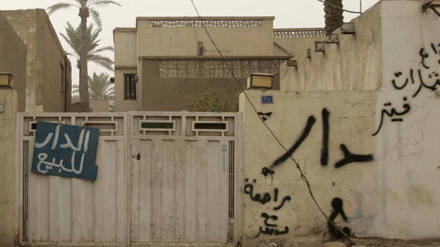 A "For Sale" sign hangs outside the gate of a house in Baghdad September 10, 2008. A dramatic fall in violence has breathed life into Baghdad's once moribund property market, but the hunt for homes in Sunni and Shi'ite enclaves bodes ill for sectarian reconciliation in the Iraqi capital.  To match feature IRAQ/REALESTATE    REUTERS/Ceerwan Aziz (IRAQ) - RTR21W89