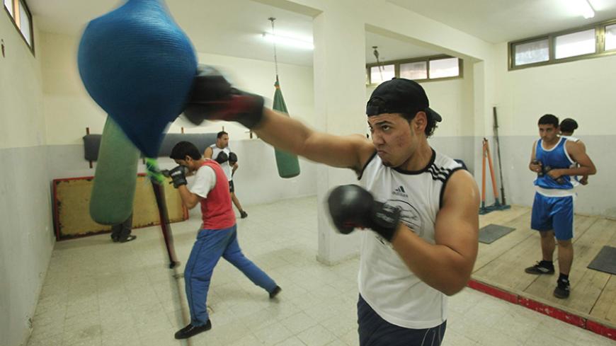 Palestinian boxers exercise in al-Nassir boxing club in Gaza City January 14, 2010. REUTERS/Mohammed Salem (GAZA - Tags: SOCIETY SPORT BOXING) - RTR28V87