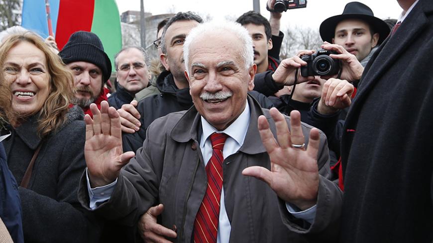 Dogu Perincek, Chairman of the Turkish Workers' Party is surrounded by supporters at the end of a hearing at the European court of Human Rights in Strasbourg, January 28, 2015. The European Court of Human Rights holds an hearing on Wednesday on the case of Perincek against Switzerland. Perincek was found guilty of racial discrimination by a Swiss Police Court for having publicly denied the characterisation of genocide, without calling into question the existence of massacres and deportations of Armenians in