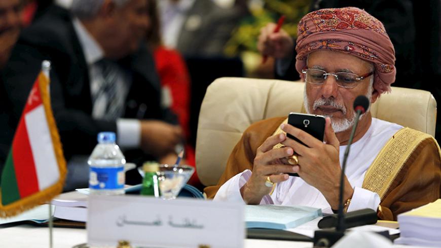 Oman's Minister of Foreign Affairs Yusuf bin Alawi bin Abdullah looks at his mobile phone at the foreign ministers of the Arab League meeting ahead of the Arab Summit in Sharm el-Sheikh, in the South Sinai governorate March 26, 2015. The Arab League on Thursday pledged full support for the Saudi-led campaign against Shi'ite Houthi fighters in Yemen.  REUTERS/Amr Abdallah Dalsh  - RTR4UZLE