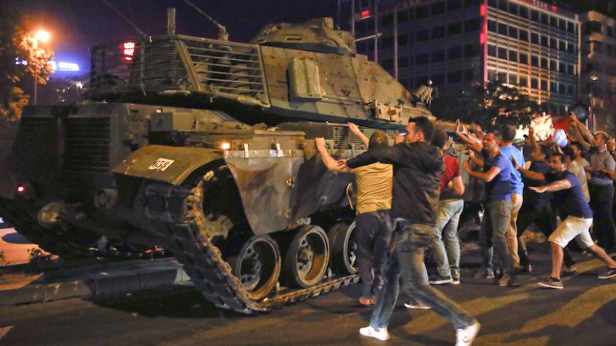 People react near a military vehicle during an attempted coup in Ankara, Turkey, July 16, 2016.     REUTERS/Tumay Berkin TPX IMAGES OF THE DAY - RTSI82W