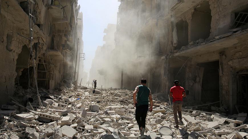 Men inspect the damage after an airstrike on the rebel held al-Qaterji neighbourhood of Aleppo, Syria September 25, 2016. REUTERS/Abdalrhman Ismail  - RTSPBZ8