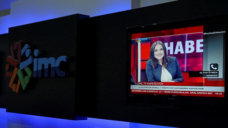 News anchor Banu Guven is seen on a screen during a news broadcast at a studio of IMC TV, a news broadcaster slated for closure, in Istanbul, Turkey, September 30, 2016. REUTERS/Huseyin Aldemir - RTSQ9GP