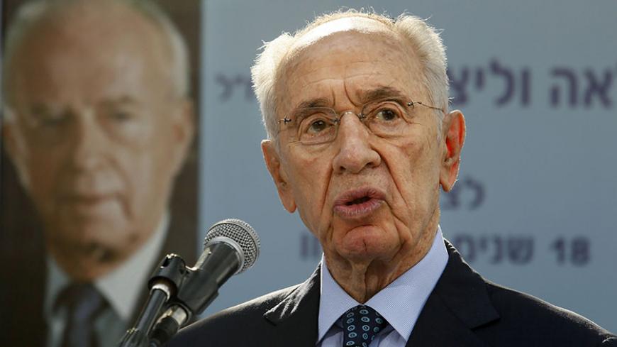 Israeli President Shimon Peres gives a speech during a ceremony for late Israeli prime minister Yitzhak Rabin at the Mount Herzl cemetery in Jerusalem October 16, 2013, marking 18 years since Rabin was assassinated at a peace rally. Rabin was shot dead on November 4, 1995 just two years after the signing of the Oslo peace accords, for which he and Peres were awarded the Nobel Peace Prize along with veteran Palestinian leader Yasser Arafat.  REUTERS/Gali Tibbon/Pool (JERUSALEM - Tags: POLITICS ANNIVERSARY HE