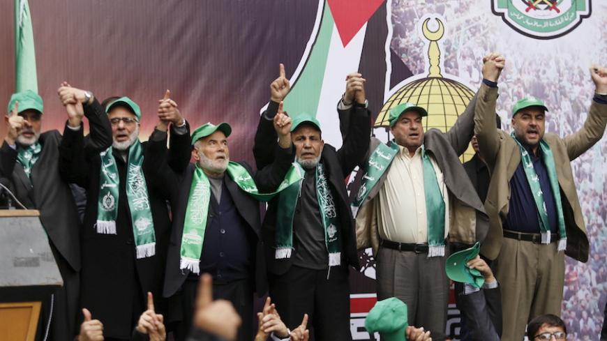 Senior Hamas leaders hold hands as they take part in a rally marking the 28th anniversary of Hamas' founding, in Gaza City December 14, 2015. REUTERS/Suhaib Salem - RTX1YLNL