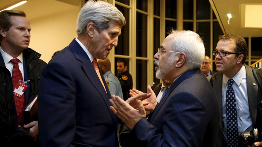 U.S. Secretary of State John Kerry talks with Iranian Foreign Minister Javad Zarif after the International Atomic Energy Agency (IAEA) verified that Iran has met all conditions under the nuclear deal, in Vienna January 16, 2016.   REUTERS/Kevin Lamarque      TPX IMAGES OF THE DAY      - RTX22PAD