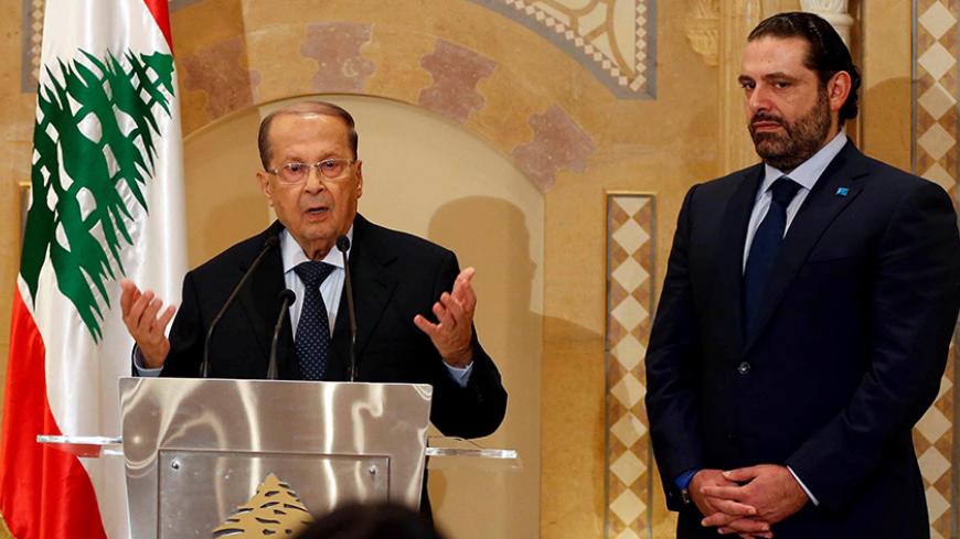 Christian politician and FPM founder Michel Aoun (L) talks during a news conference next to Lebanon's former prime minister Saad al-Hariri after he said he will back Aoun to become president in Beirut, Lebanon October 20, 2016. REUTERS/Mohamed Azakir - RTX2PR3I