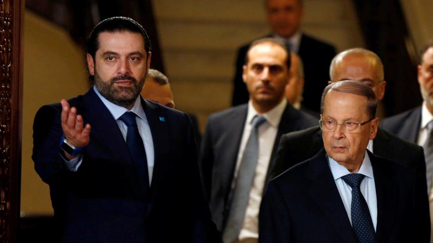 Christian politician and FPM founder Michel Aoun (L) walks next to Lebanon's former prime minister Saad al-Hariri after he said he will back Aoun to become president in Beirut, Lebanon October 20, 2016. REUTERS/Mohamed Azakir     TPX IMAGES OF THE DAY      - RTX2PSCO