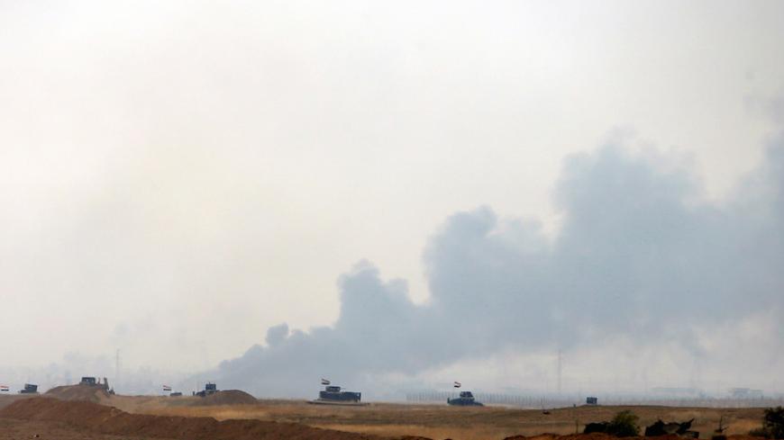 Iraqi army vehicles are seen pushing into Topzawa village during the operation against Islamic State militants near Bashiqa, near Mosul, Iraq October 24, 2016. REUTERS/Azad Lashkari - RTX2Q8P7