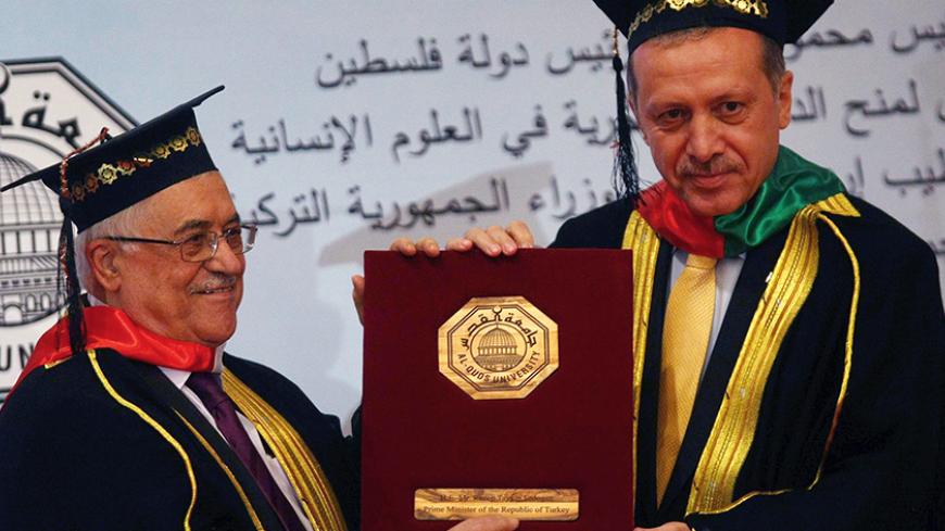 Turkish Prime Minister Recep Tayyip Erdogan (R) poses with president of Palestine Mahmoud Abbas as he receives an honorary doctorate degree from Palestine's Al-Quds University in Ankara on September 21, 2012. AFP PHOTO / ADEM ALTAN        (Photo credit should read ADEM ALTAN/AFP/GettyImages)