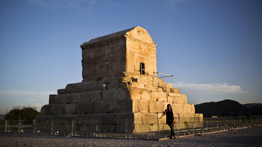 An Iranian woman poses for a picture on May 19, 2015, in front of the tomb of Cyrus II of Persia, known as Cyrus the Great, the founder of the Persian Achaemenid Empire in 6th century BCE in the town of Pasargadae, 135 kilometers north east of the southern city of shiraz. Under his rule, the Achaemenid Empire created the largest empire the world had yet seen. Cuneiform records from Babylon suggest that Cyrus died on 4 December 530 BCE, but according to the Greek historian, Herodotus, Cyrus was killed near t