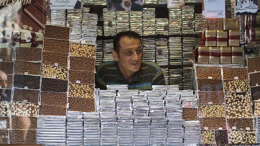 A chocolate seller waits for customers as he waits in his booth in Istanbul September 22, 2009. REUTERS/Morteza Nikoubazl    (TURKEY FOOD BUSINESS) - RTR285V8