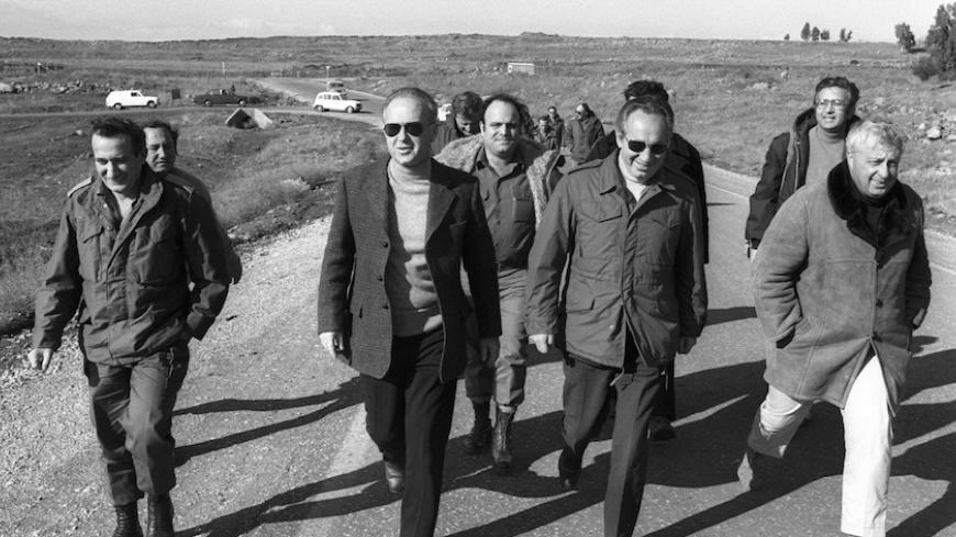 Israel's Prime Minister Yitzhak Rabin (2nd L), Defence Minister Shimon Peres and Security Advisor Ariel Sharon (R) walk together during a visit to an army base in the Golan Heights in this file picture taken December 11, 1975 and released by the Israeli Government Press Office (GPO). REUTERS/Yaacov Sa'ar/GPO/Handout (POLITICS) FOR EDITORIAL USE ONLY. NOT FOR SALE FOR MARKETING OR ADVERTISING CAMPAIGNS. ISRAEL OUT. NO COMMERCIAL OR EDITORIAL SALES IN ISRAEL. BLACK AND WHITE ONLY - RTR2UFU7