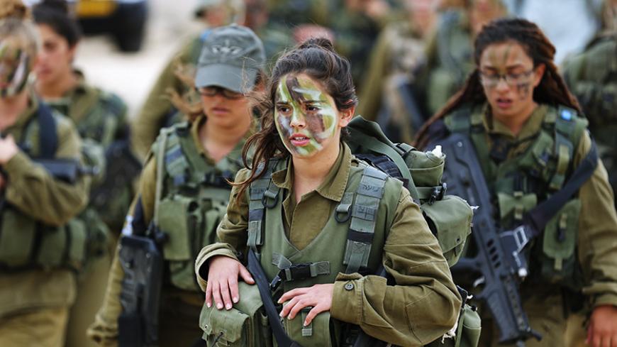 Israeli soldiers of the Caracal battalion walk together during a 23-kilometre march marking the end of their training in Israel's Negev desert, near Kibbutz Sde Boker February 14, 2013. The "Caracal" battalion, two-thirds of whose members are women, was established in 2004 with the purpose of incorporating female soldiers in combat units. The main mission of Caracal is routine patrols on Israel's border with Egypt to intercept infiltrators and smuggling from the Sinai desert. REUTERS/Darren Whiteside (ISRAE