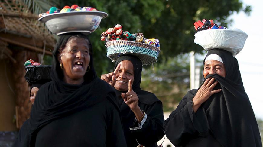 Nubian women sell traditional handicrafts at the Nubian Gharb Suheil village, near Aswan south of Egypt, October 1, 2015.  For half a century, Egypt's Nubians have patiently lobbied the government in Cairo for a return to their homelands on the banks of the upper Nile, desperate to reclaim territory their ancestors first cultivated 3,000 years ago.  Picture taken October 1, 2015.   REUTERS/Mohamed Abd El Ghany.      TPX IMAGES OF THE DAY      - RTS7J7U