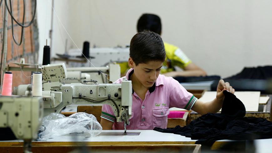 Muhamed, a Syrian refugee boy, works at a small textile factory in Istanbul, Turkey, June 24, 2016. Picture taken June 24, 2016.   To match Special Report EUROPE-MIGRANTS/TURKEY-CHILDREN    REUTERS/Murad Sezer - RTSJN5J