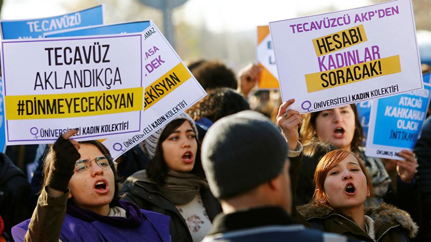 Protesters shout slogans during a protest against a proposal that would have allowed sentencing in cases of sexual abuse committed "without force, threat or trick" before Nov. 16, 2016 to be indefinitely postponed if the perpetrator marries the victim, in front of the Turkish Parlaiment in Ankara, Turkey, November 22, 2016. Banners read, "if the rape will be legitimized the rebellion will go on" (L) and "the bill will be asked from rapist AK Party (AKP) by women (R)" REUTERS/Umit Bektas - RTSSRLU