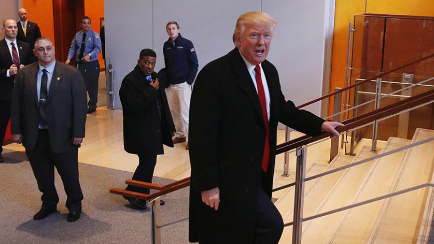 U.S. President elect Donald Trump walks up a staircase to depart the lobby of the New York Times building after a meeting in New York, U.S., November 22, 2016.  REUTERS/Lucas Jackson - RTSSUCX
