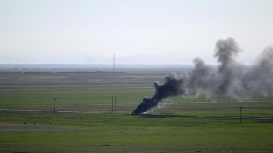 Smoke rises from an Islamic State vehicle near al-Shadadi town, Hasaka countryside Syria February 18, 2016. REUTERS/Rodi Said  - RTX27LEW