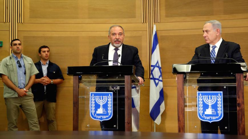 Israeli prime minister Benjamin Netanyahu (R) listens as Israel's new Defence Minister Avigdor Lieberman, head of far-right Yisrael Beitenu party, speaks during a media conference following Lieberman's swearing-in ceremony at the Knesset, the Israeli parliament, in Jerusalem May 30, 2016. REUTERS/Ronen Zvulun     TPX IMAGES OF THE DAY      - RTX2EVP3