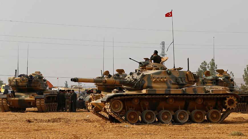 Turkish army tanks and military personal are stationed in Karkamis on the Turkish-Syrian border in the southeastern Gaziantep province, Turkey, August 25, 2016. REUTERS/Umit Bektas - RTX2MYL0