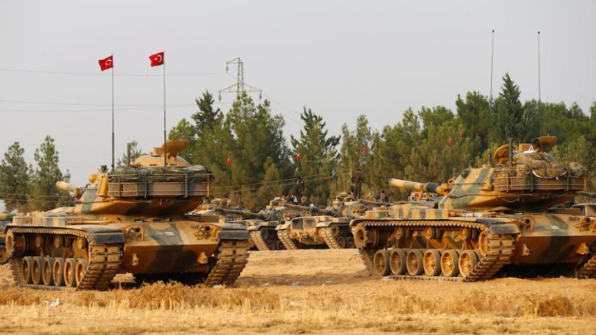 Turkish army tanks and military personal are stationed in Karkamis on the Turkish-Syrian border in the southeastern Gaziantep province, Turkey, August 25, 2016. REUTERS/Umit Bektas - RTX2MYWR