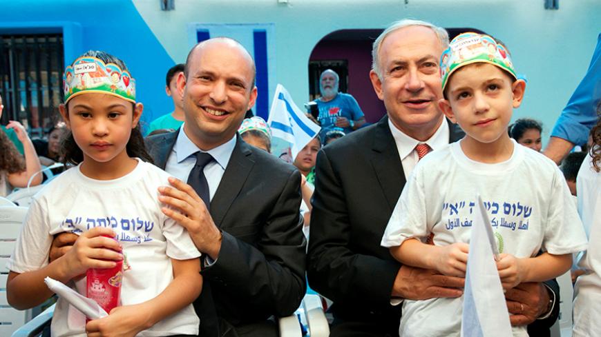 Israeli Prime Minister Benjamin Netanyahu (R) and Education Minister Naftali Bennett with pupils during a visit at the "Tamra HaEmek" elementary school on the first day of the school year, in the Arab Israeli town of Tamra, Israel September 1, 2016. REUTERS/Baz Ratner - RTX2NR9F
