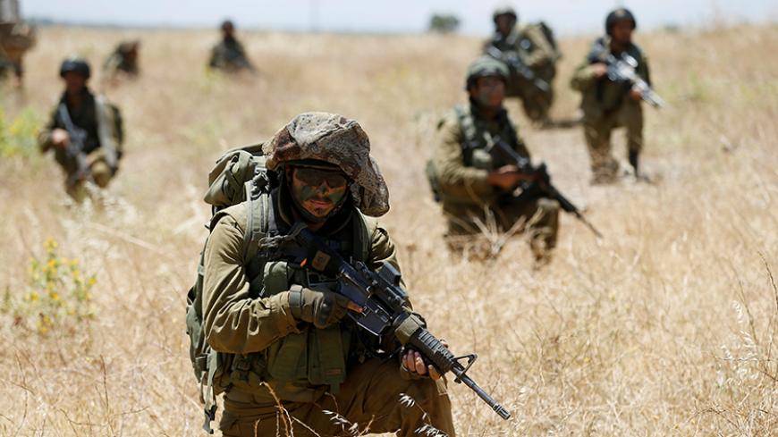 Israeli soldiers from the 605 Combat Engineering Corps battalion take part in a training session on the Israeli side of the border between Syria and the Israeli-occupied Golan Heights June 1, 2016. REUTERS/Baz Ratner/File Photo - RTX2O7HR