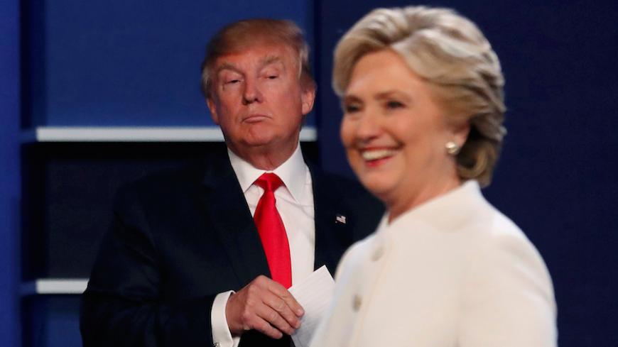 Republican U.S. presidential nominee Donald Trump and Democratic U.S. presidential nominee Hillary Clinton finish their third and final 2016 presidential campaign debate at UNLV in Las Vegas, Nevada, U.S., October 19, 2016.      REUTERS/Mike Blake       TPX IMAGES OF THE DAY      - RTX2PMHB