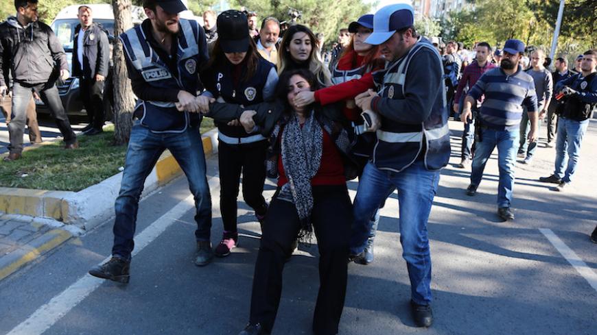 Police detain Sebahat Tuncel, co-chair of the pro-Kurdish Democratic Regions Party (DBP), during a protest against the arrest of Kurdish lawmakers, in the southeastern city of Diyarbakir, Turkey, November 4, 2016. REUTERS/Sertac Kayar - RTX2RWQJ