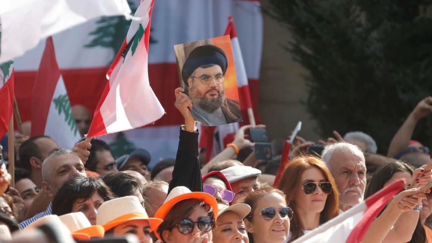 A woman carries a picture of Hezbollah leader Hassan Nasrallah during an event to celebrate Lebanese President Michel Aoun's presidency, at the presidential palace in Baabda, near Beirut, Lebanon November 6, 2016. REUTERS/Mohamed Azakir - RTX2S4L6