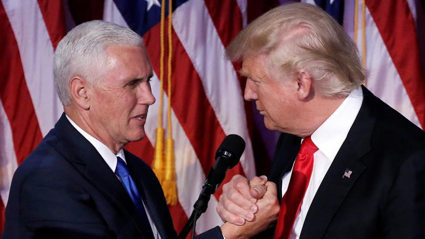 U.S. President-elect Donald Trump and Vice President-elect Mike Pence embrace at their election night rally in Manhattan, New York, U.S., November 9, 2016. REUTERS/Mike Segar - RTX2SVO5