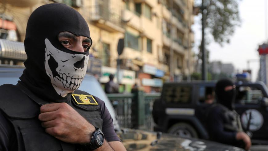A masked member of security forces is pictured as they secure Tahrir Square in Cairo, Egypt, November 11, 2016. REUTERS/Mohamed Abd El Ghany - RTX2T83N