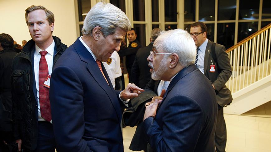 US Secretary of State John Kerry (L) speaks with Iranian Foreign Minister Mohammad Javad Zarif after the International Atomic Energy Agency (IAEA) verified that Iran has met all conditions under the nuclear deal during the E3/EU+3 and Iran talks in Vienna on January 16, 2016.
The historic nuclear accord between Iran and major powers entered into force as the UN confirmed that Tehran has shrunk its atomic programme and as painful sanctions were lifted on the Islamic republic. / AFP / POOL / KEVIN LAMARQUE   