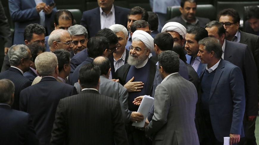 Iran's President Hassan Rouhani (C) speaks with MPs after presenting his budget for 2017-2018 to the parliament on December 4, 2016, in Tehran. / AFP / ATTA KENARE        (Photo credit should read ATTA KENARE/AFP/Getty Images)