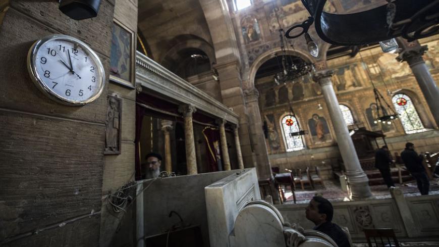 Egyptian security forces and members of the clergy inspect the scene of a bomb explosion at the Saint Peter and Saint Paul Coptic Orthodox Church on December 11, 2016, in Cairo's Abbasiya neighbourhood.
The blast killed at least 25 worshippers during Sunday mass inside the Cairo church near the seat of the Coptic pope who heads Egypt's Christian minority, state media said. / AFP / KHALED DESOUKI        (Photo credit should read KHALED DESOUKI/AFP/Getty Images)