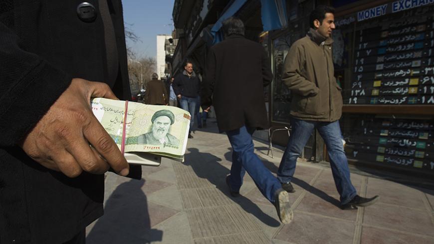 EDITORS' NOTE: Reuters and other foreign media are subject to Iranian restrictions on leaving the office to report, film or take pictures in Tehran.

A money changer holds Iranian rial banknotes as he waits for customers in Tehran's business district January 7, 2012. REUTERS/Raheb Homavandi  (IRAN - Tags: BUSINESS) - RTR2VZCL