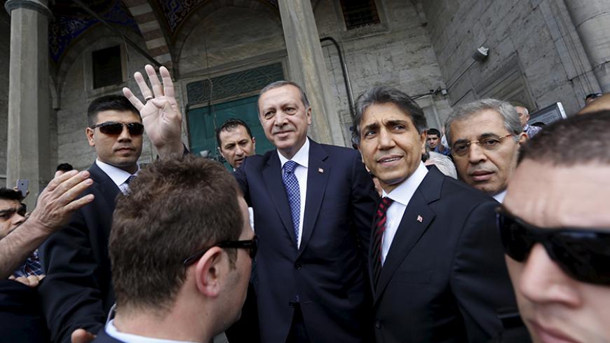 Turkey's President Tayyip Erdogan (C) greets his supporters as he arrives at a mosque for Friday prayers in Istanbul, Turkey, May 29, 2015. Turkish President Tayyip Erdogan said the launch of Ziraat Bank's Islamic business should help to attract new funds to Turkey and urged other state lenders to help to triple Islamic banking's share of the market by 2023. Islamic finance has developed slowly in Turkey, the world's eighth most populous Muslim nation, partly because of political sensitivities and the secul
