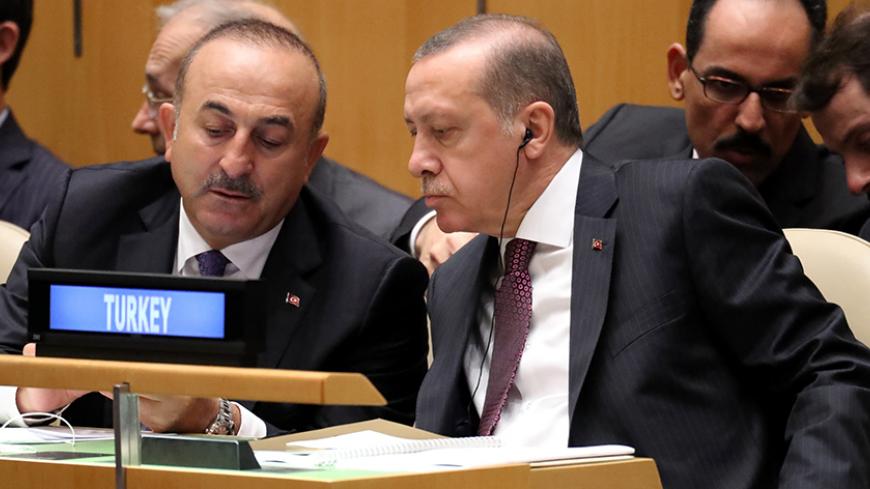 President Recep Tayyip Erdogan of Turkey speaks with his Foreign Minister Mevlut Cavusoglu (L) during the 71st United Nations General Assembly in Manhattan, New York, U.S. September 20,  2016. REUTERS/Carlo Allegri - RTSOLUH