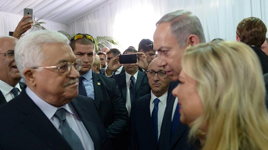 Israeli Prime Minister Benjamin Netanyahu and his wife Sara speak to Palestinian President Mahmoud Abbas (L) during the funeral of former Israeli President Shimon Peres in Jerusalem September 30, 2016.  Amos Ben Gershom/Government Press Office (GPO)/Handout via REUTERS ATTENTION EDITORS - THIS IMAGE HAS BEEN SUPPLIED BY A THIRD PARTY. IT IS DISTRIBUTED, EXACTLY AS RECEIVED BY REUTERS, AS A SERVICE TO CLIENTS. FOR EDITORIAL USE ONLY.  - RTSQ6QG