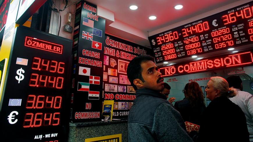 People check currency exchange rates at an currency exchange office in Istanbul, Turkey, November 25, 2016. REUTERS/Murad Sezer - RTST8W8