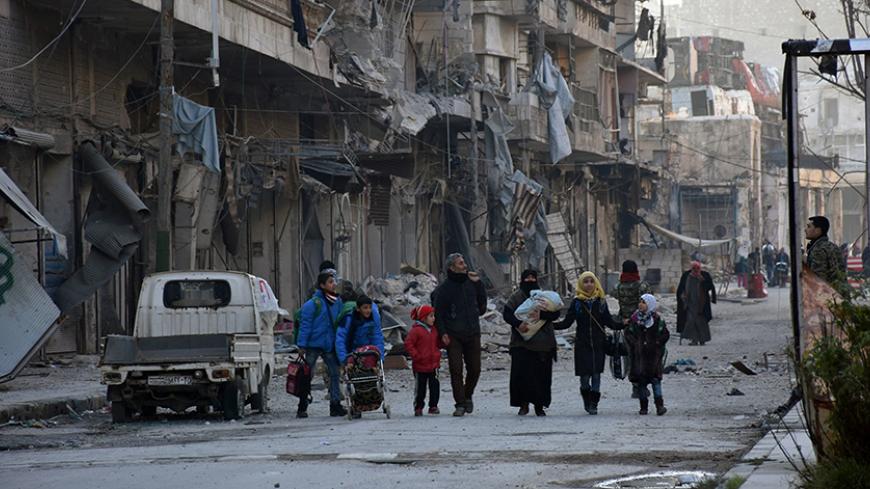 People, who evacuated the eastern districts of Aleppo, carry their belongings as they arrive in a government held area of Aleppo, Syria, in this handout picture provided by SANA on December 7, 2016. SANA/Handout via REUTERS ATTENTION EDITORS - THIS PICTURE WAS PROVIDED BY A THIRD PARTY. REUTERS IS UNABLE TO INDEPENDENTLY VERIFY THE AUTHENTICITY, CONTENT, LOCATION OR DATE OF THIS IMAGE. FOR EDITORIAL USE ONLY. - RTSV3U9