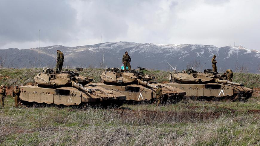 Israeli soldiers stand atop tanks in the Golan Heights near Israel's border with Syria March 19, 2014. REUTERS/Ronen Zvulun/File Photo - RTX2JLDC