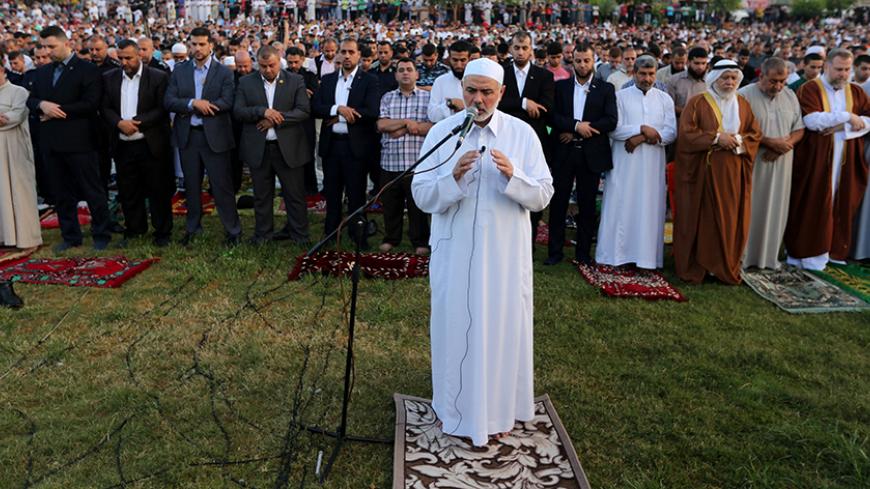 Senior Hamas leader Ismail Haniyeh leads the morning prayers for Eid al-Fitr celebrations, which marks the end of the holy fasting month of Ramadan, in Gaza City July 6, 2016. REUTERS/Ibraheem Abu Mustafa - RTX2JVUJ