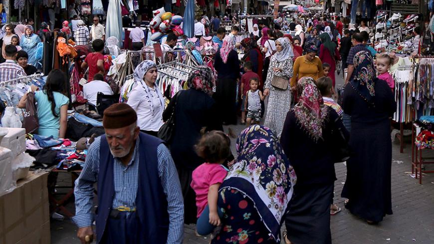 People shop at an open air bazaar in Baglar neighborhood in the Kurdish-dominated southeastern city of Diyarbakir, Turkey, September 5, 2016. Picture taken September 5, 2016. REUTERS/Sertac Kayar - RTX2OAM3