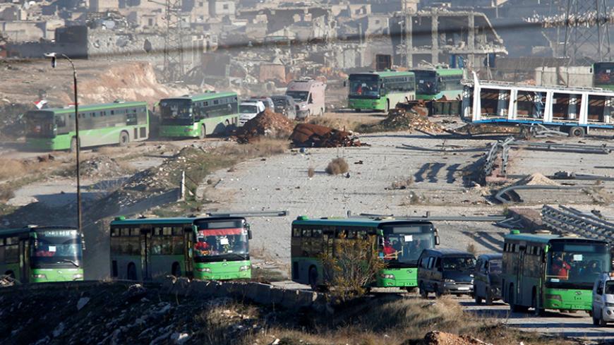 Ambulances and buses evacuating people drive out of a rebel-held part of Aleppo, Syria December 15, 2016. REUTERS/Omar Sanadiki     TPX IMAGES OF THE DAY - RTX2V7EI